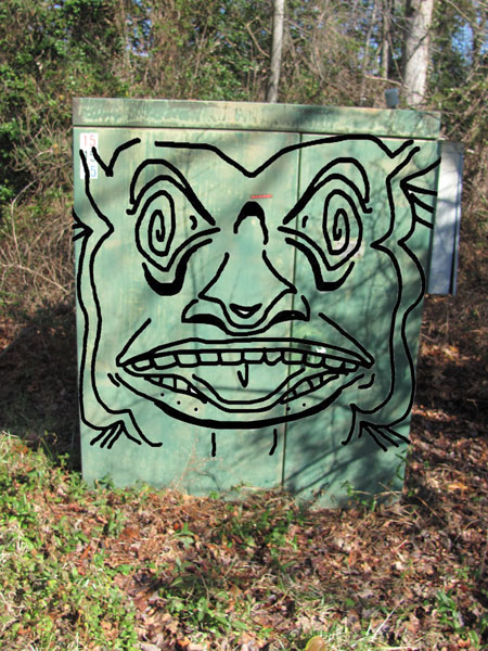 box with totem pole face